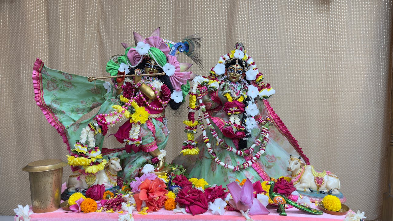 Ornate sculptures of Hindu deities adorned with vibrant floral garlands and decorations.